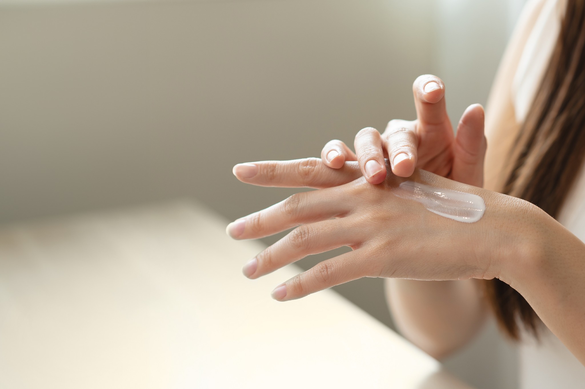 Woman applying hand lotion