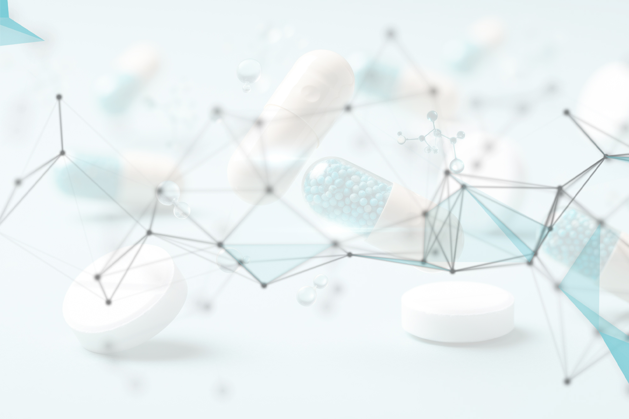 Various pills and capsules on a light teal background